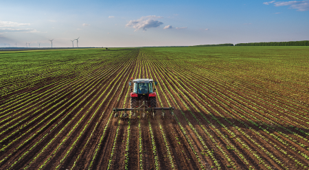 tractor tending to the field on a sunny day